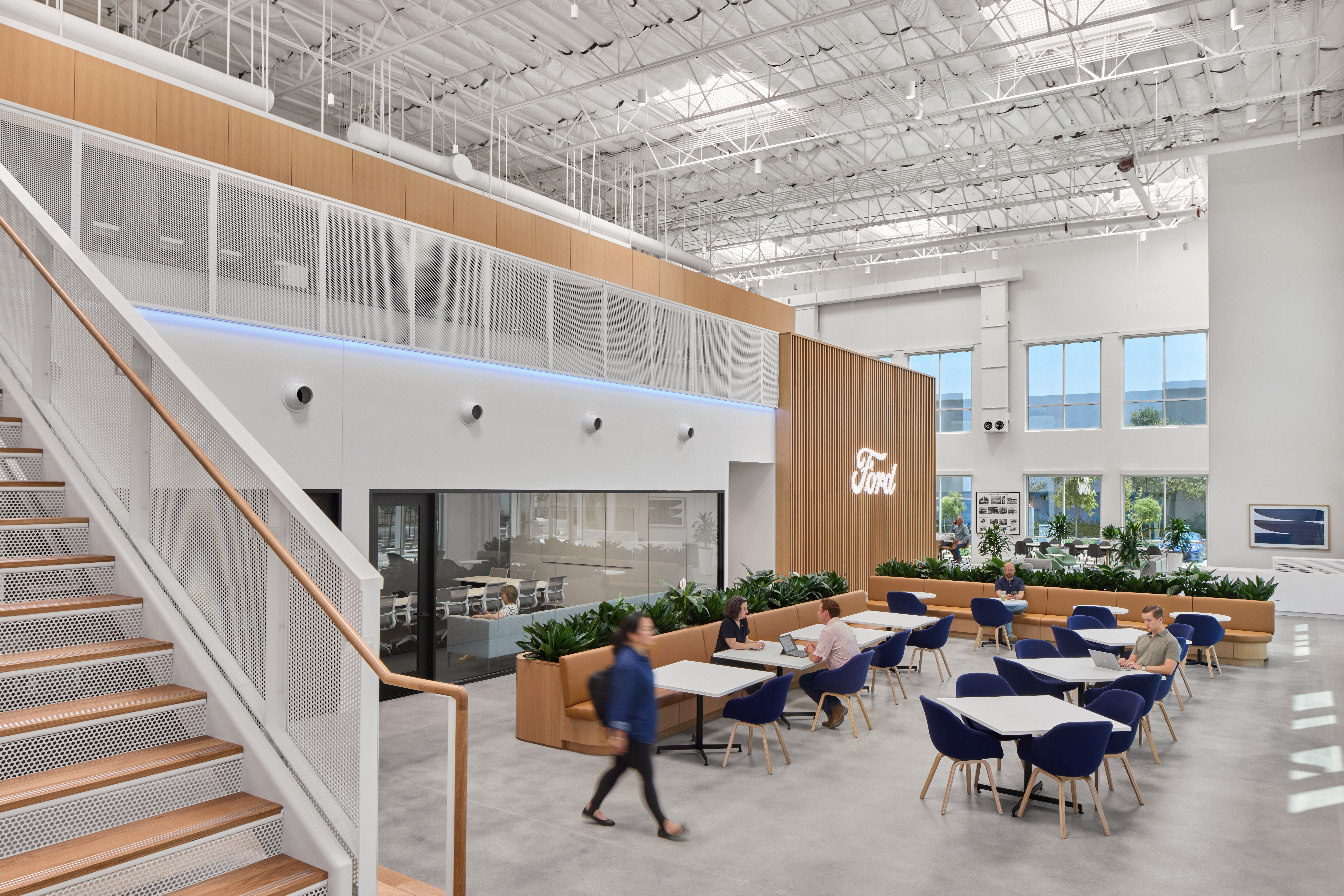 An architectural rendering of an office space with natural wood tones, white walls, open space, plant accents and a lot of natural light.